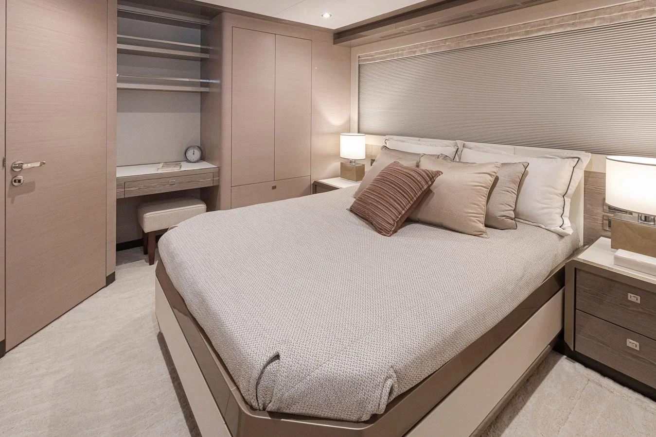 A luxurious stateroom featuring a large bed with plush pillows and modern furnishings. aboard STILL WATERS Yacht for Sale