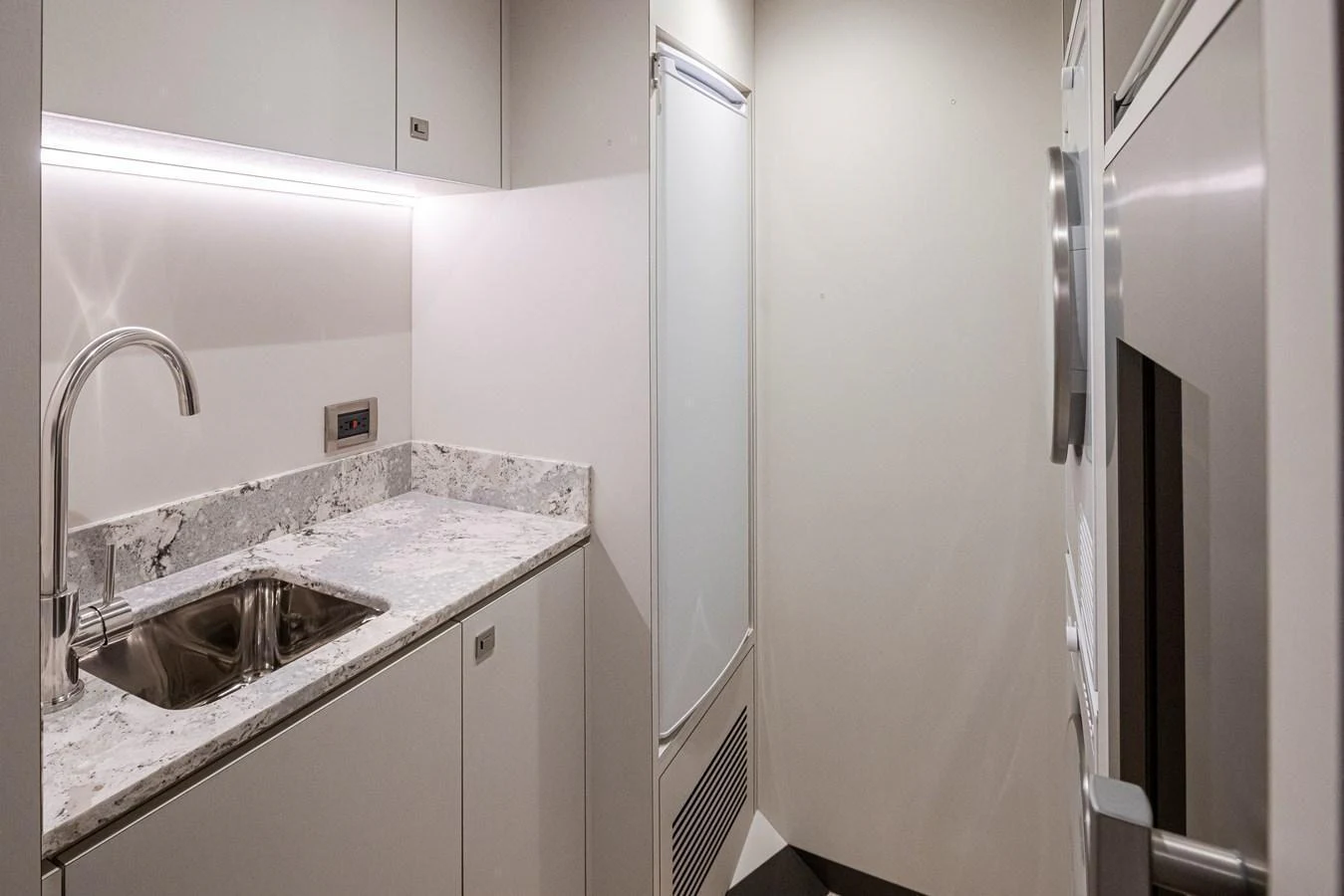 The compact galley features modern appliances and sleek countertops. aboard STILL WATERS Yacht for Sale