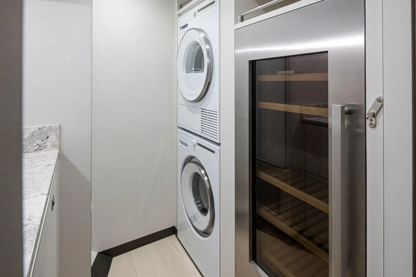 The yacht features a compact and efficient laundry area with modern appliances. aboard STILL WATERS Yacht for Sale