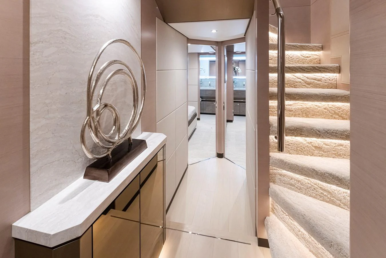 A luxurious hallway with modern decor and a staircase leading to the upper deck. aboard STILL WATERS Yacht for Sale