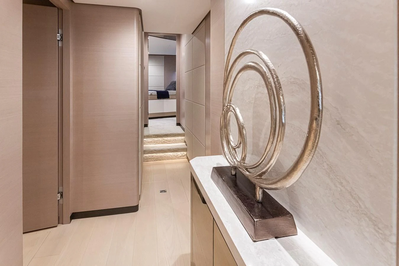 A sleek and modern hallway with elegant decor leads to a cozy stateroom. aboard STILL WATERS Yacht for Sale