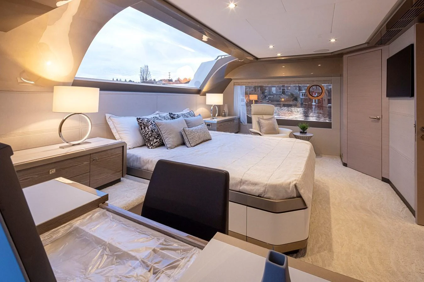 The master stateroom features a luxurious bed with elegant decor and ample natural light. aboard STILL WATERS Yacht for Sale
