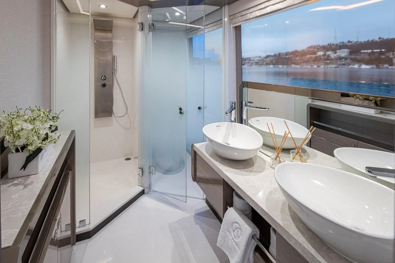 The yacht's bathroom features a modern design with dual sinks and a spacious shower. aboard STILL WATERS Yacht for Sale
