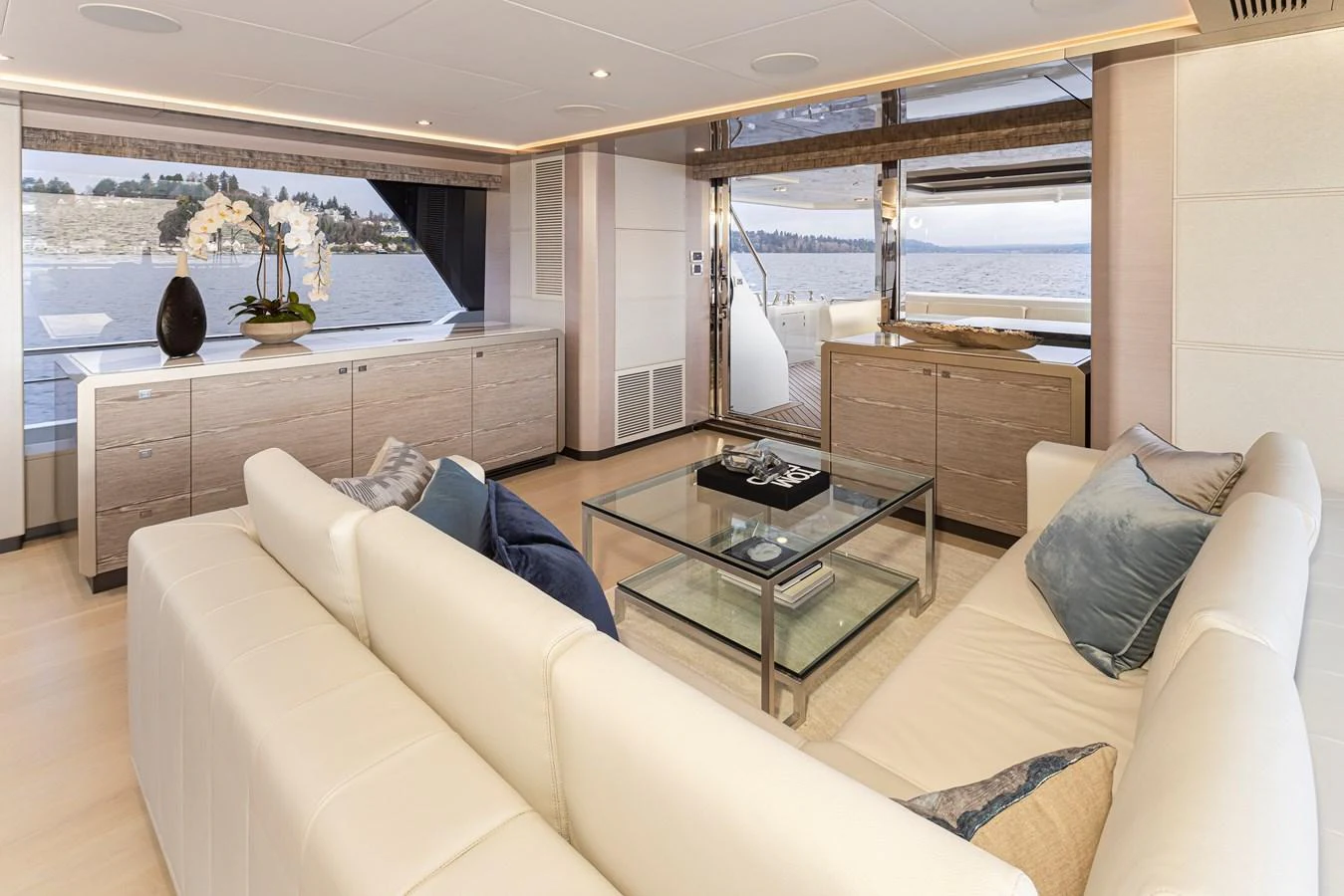 The salon features elegant furnishings with a spacious layout and large windows offering stunning views. aboard STILL WATERS Yacht for Sale