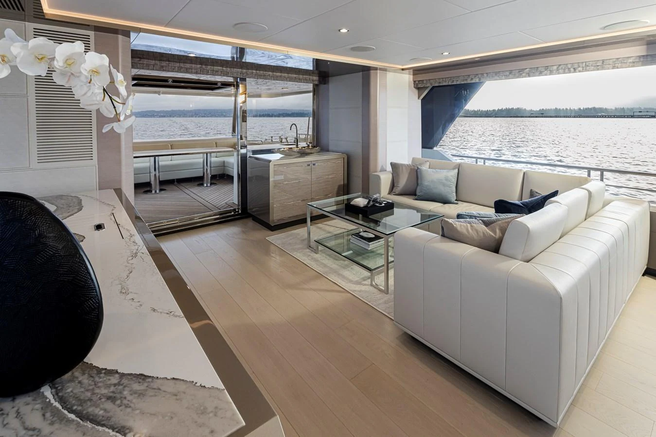 The yacht's salon features a luxurious seating area with panoramic views of the water. aboard STILL WATERS Yacht for Sale