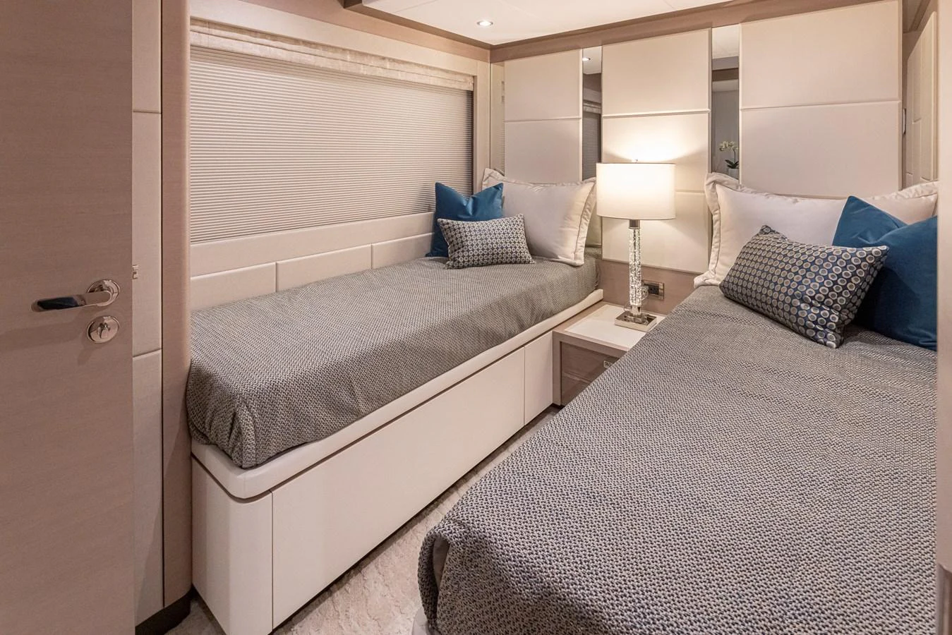 A cozy twin stateroom with modern decor and soft lighting. aboard STILL WATERS Yacht for Sale