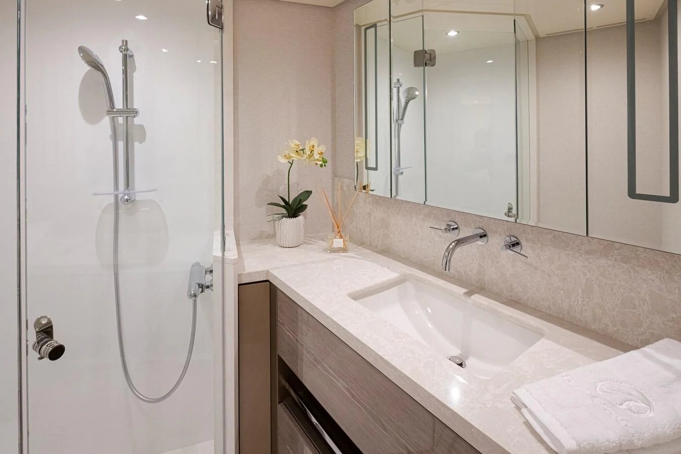 A modern yacht bathroom featuring a sleek shower and elegant vanity. aboard STILL WATERS Yacht for Sale