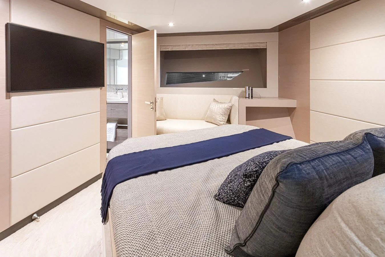 The stateroom features a comfortable bed with elegant bedding and a modern design. aboard STILL WATERS Yacht for Sale