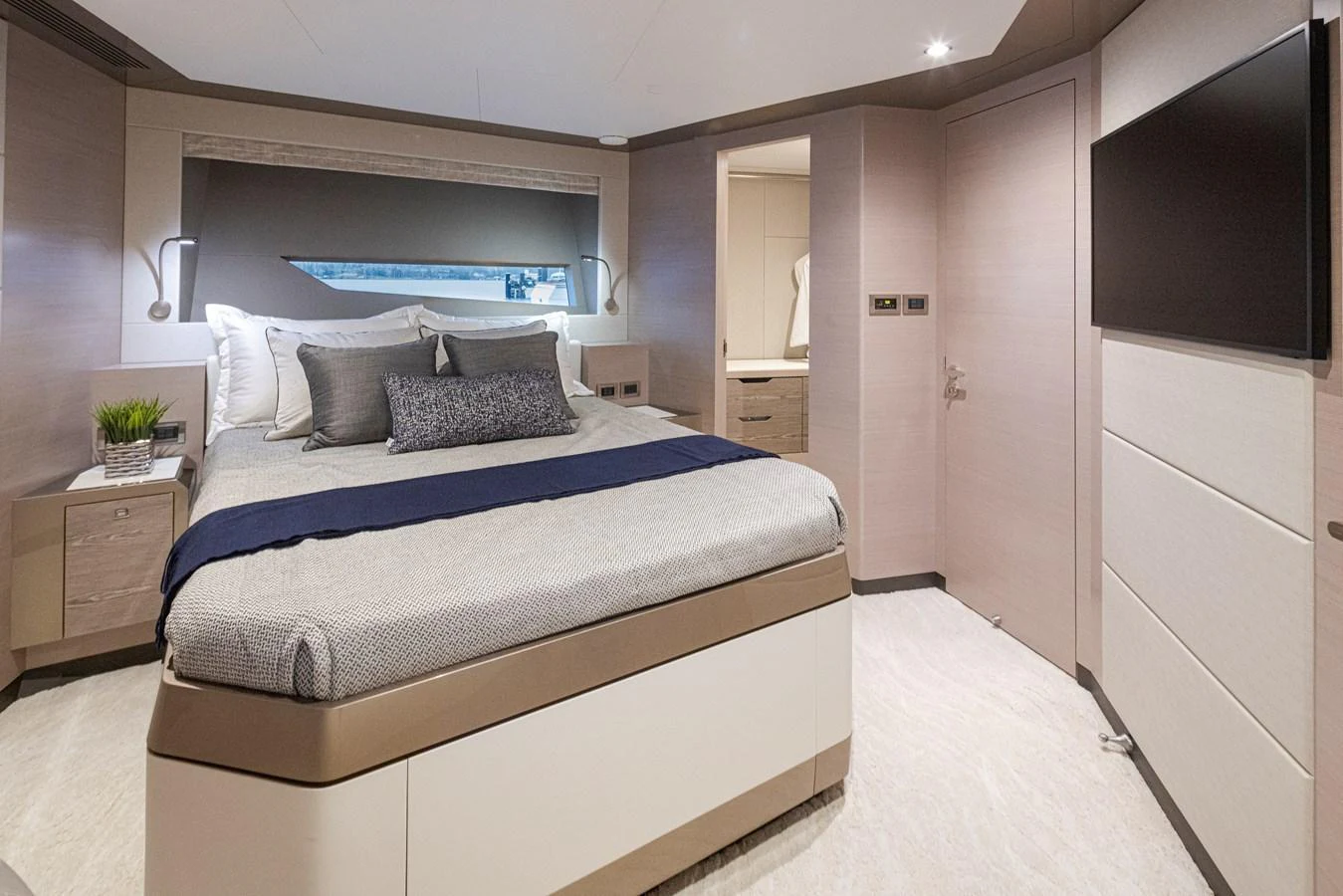 The stateroom features a plush bed with modern decor and ample natural light. aboard STILL WATERS Yacht for Sale