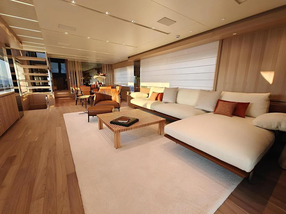 The yacht's salon features a spacious and elegantly designed seating area with modern furnishings and warm lighting. aboard NADINKA Yacht for Sale