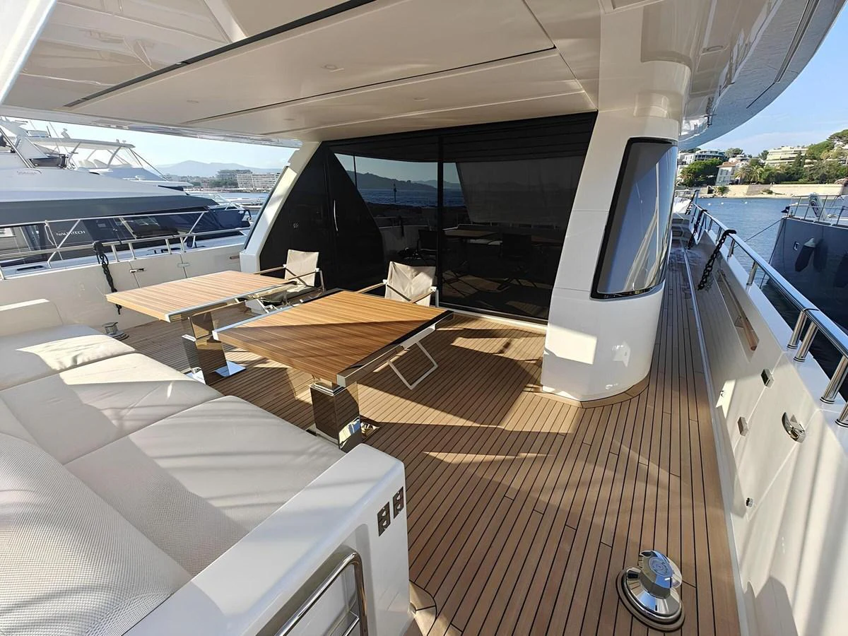 The aft deck offers a spacious and elegant outdoor seating area with modern furnishings and a beautiful view of the marina. aboard NADINKA Yacht for Sale
