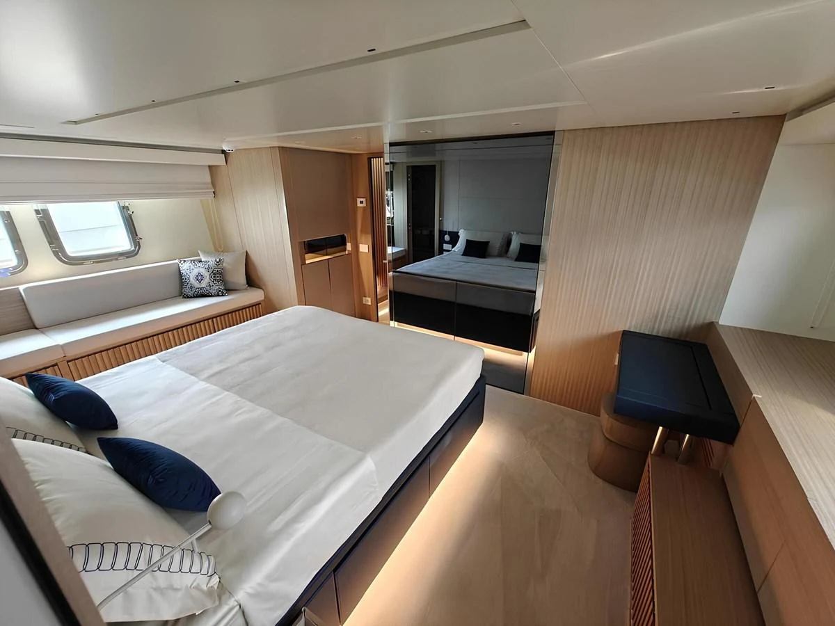 The stateroom features a spacious bed, modern furnishings, and ample natural light. aboard NADINKA Yacht for Sale
