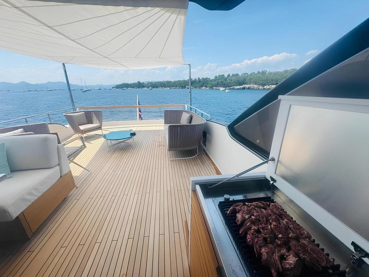 The aft deck features a spacious seating area and a barbecue grill, perfect for outdoor dining and relaxation. aboard NADINKA Yacht for Sale