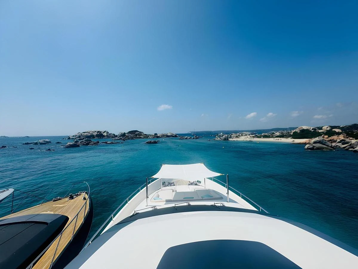 The yacht is cruising through clear blue waters with a stunning view of the surrounding seascape. aboard NADINKA Yacht for Sale