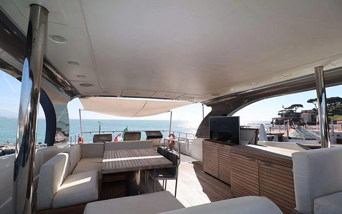 The aft deck offers a spacious and shaded area for relaxation and dining with a beautiful view of the sea. aboard MEP TOGETHER Yacht for Sale