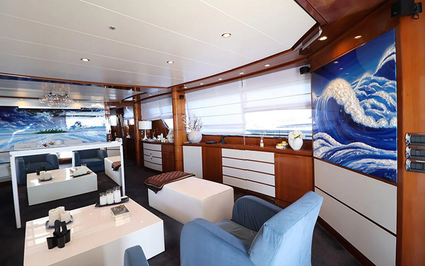 The yacht's salon features elegant furnishings and a serene ambiance with a stunning ocean-themed artwork. aboard MEP TOGETHER Yacht for Sale