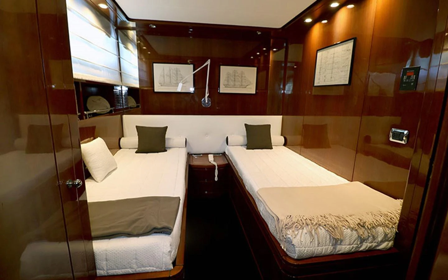 A cozy twin stateroom with polished wood finishes and modern lighting. aboard MEP TOGETHER Yacht for Sale