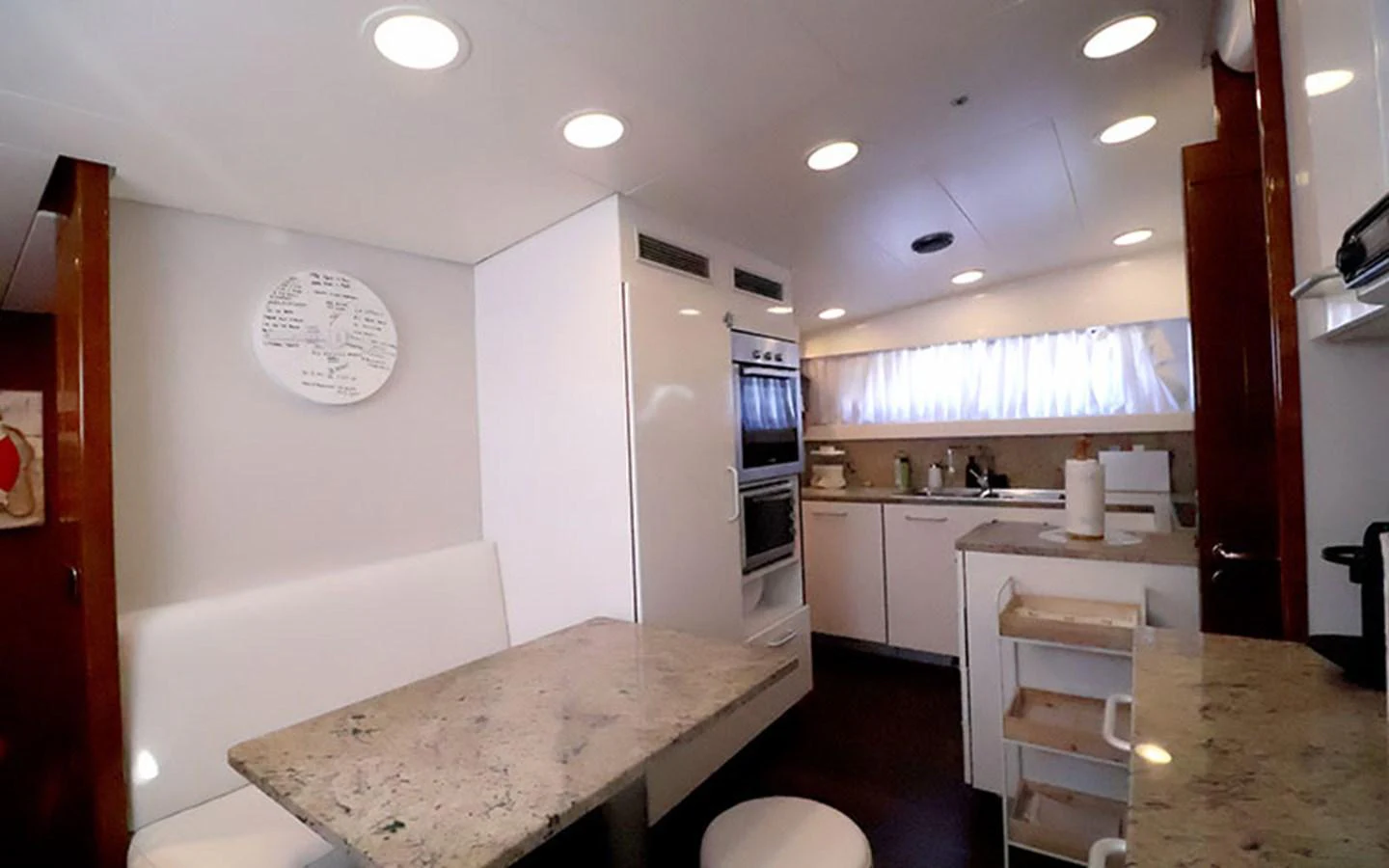 The yacht's galley features a cozy dining area with modern appliances and ample counter space. aboard MEP TOGETHER Yacht for Sale