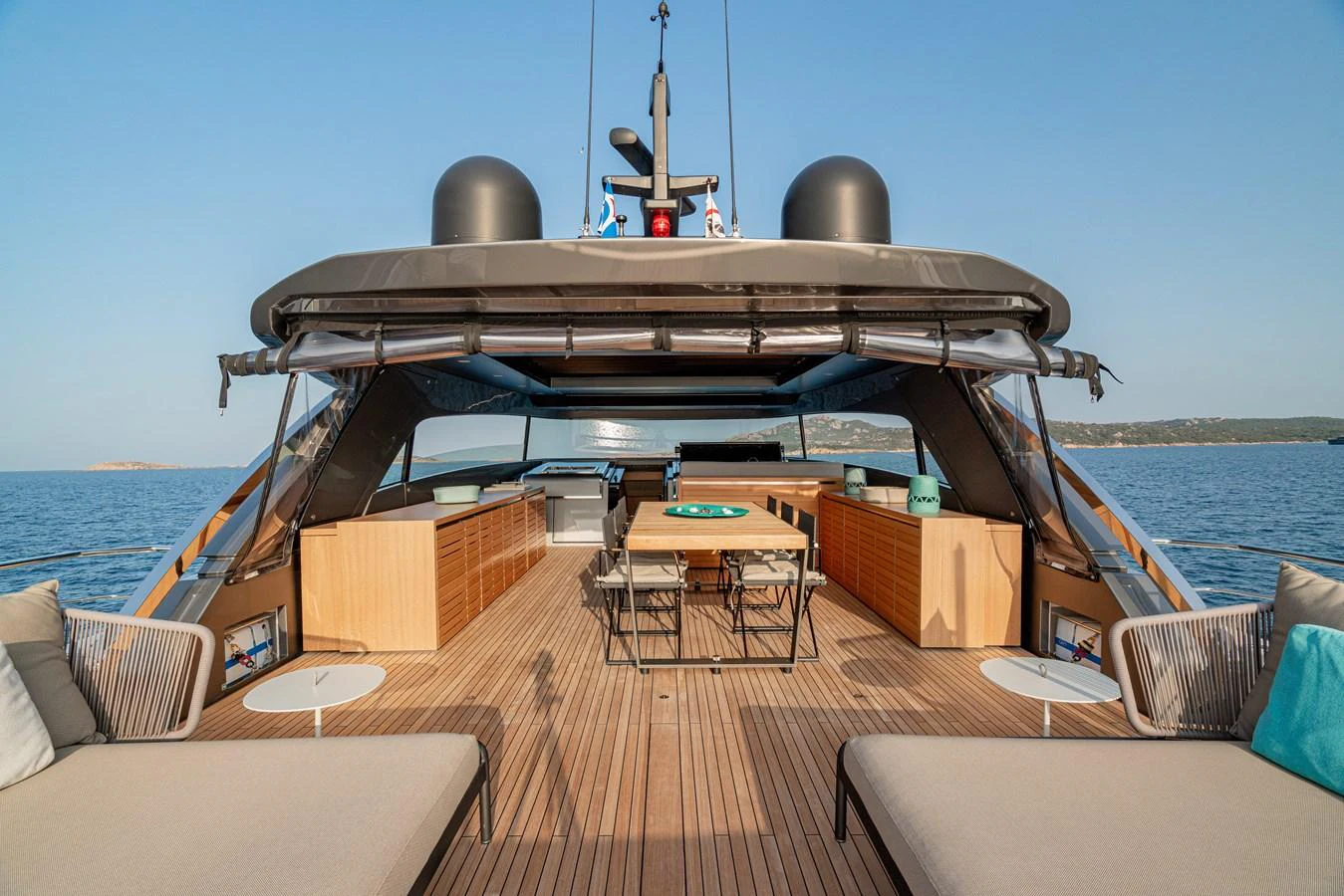 The aft deck features a spacious lounging area with sunbeds and a dining table, perfect for outdoor relaxation and dining. aboard SANLORENZO SX 88 M&M Yacht for Sale