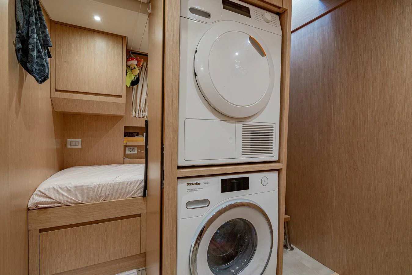 The yacht features a compact and efficient laundry area with modern appliances. aboard SANLORENZO SX 88 M&M Yacht for Sale