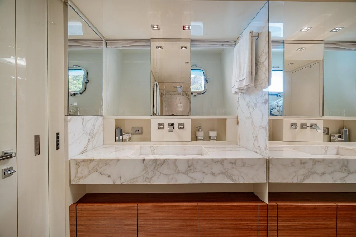 The yacht's bathroom features a luxurious marble countertop with modern fixtures and ample storage. aboard SANLORENZO SX 88 M&M Yacht for Sale