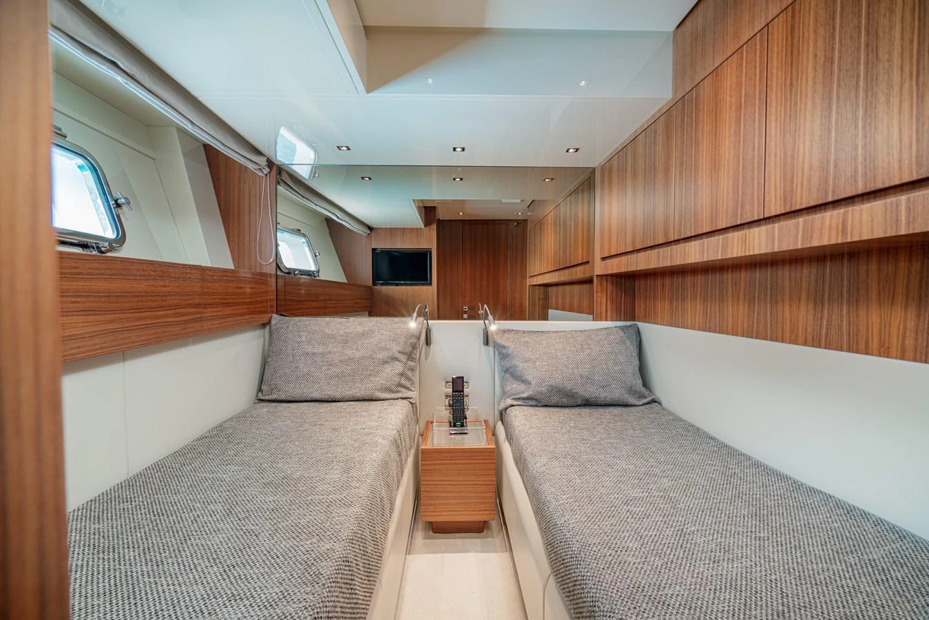 The twin cabin features sleek wood paneling and comfortable twin beds with modern decor. aboard SANLORENZO SX 88 M&M Yacht for Sale