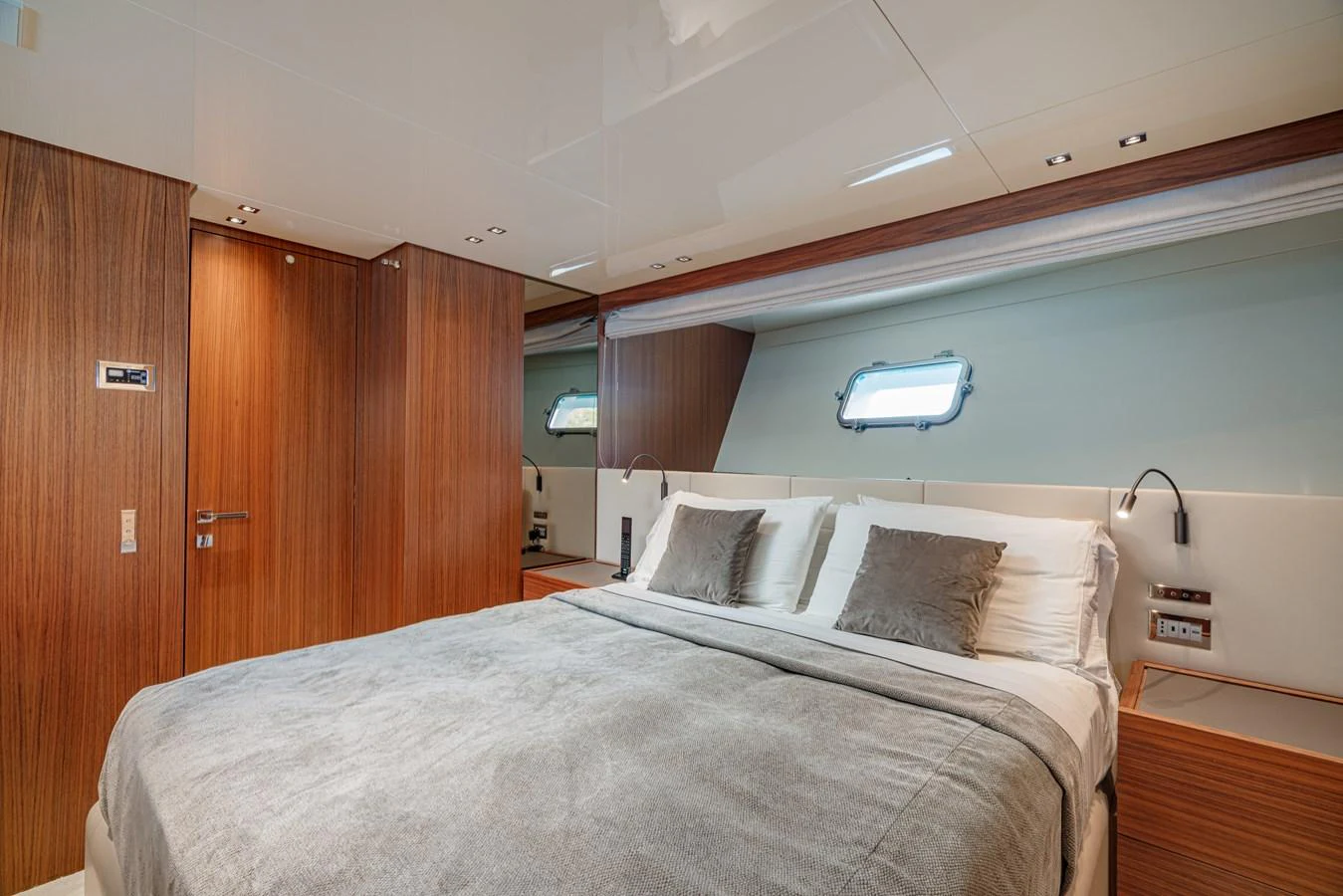 The stateroom features a plush bed with elegant wood paneling and ample natural light. aboard SANLORENZO SX 88 M&M Yacht for Sale
