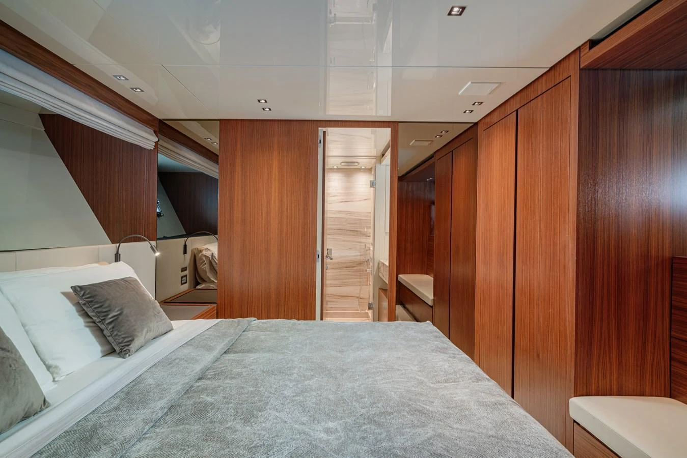 The stateroom features elegant wood paneling and a plush bed with luxurious linens. aboard SANLORENZO SX 88 M&M Yacht for Sale