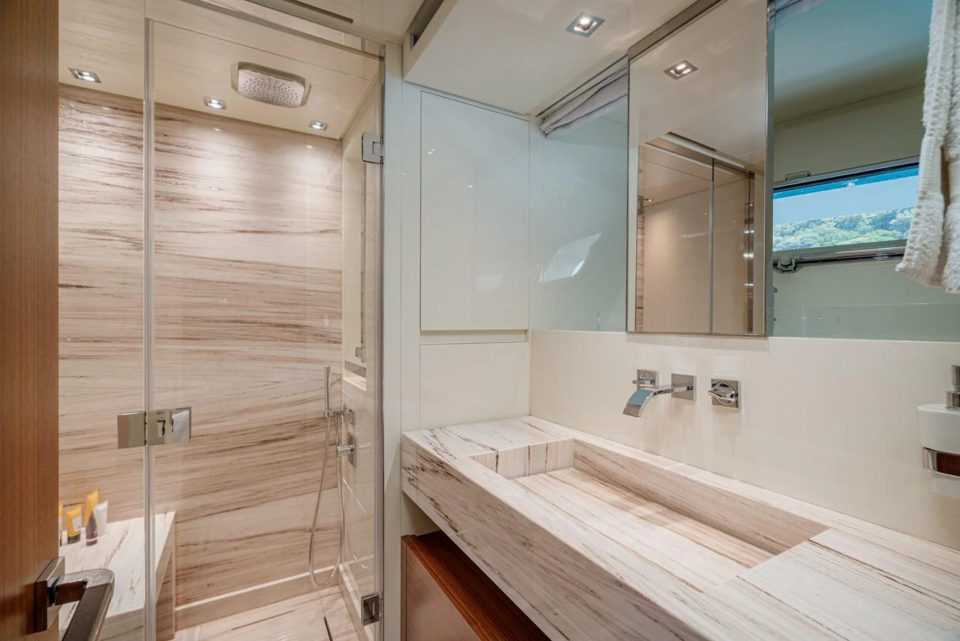 The yacht's bathroom features a sleek, modern design with a spacious shower and elegant fixtures. aboard SANLORENZO SX 88 M&M Yacht for Sale