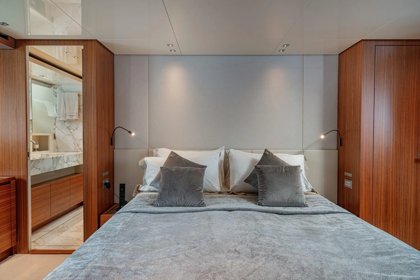 The stateroom features a plush bed with elegant wooden accents and modern lighting. aboard SANLORENZO SX 88 M&M Yacht for Sale