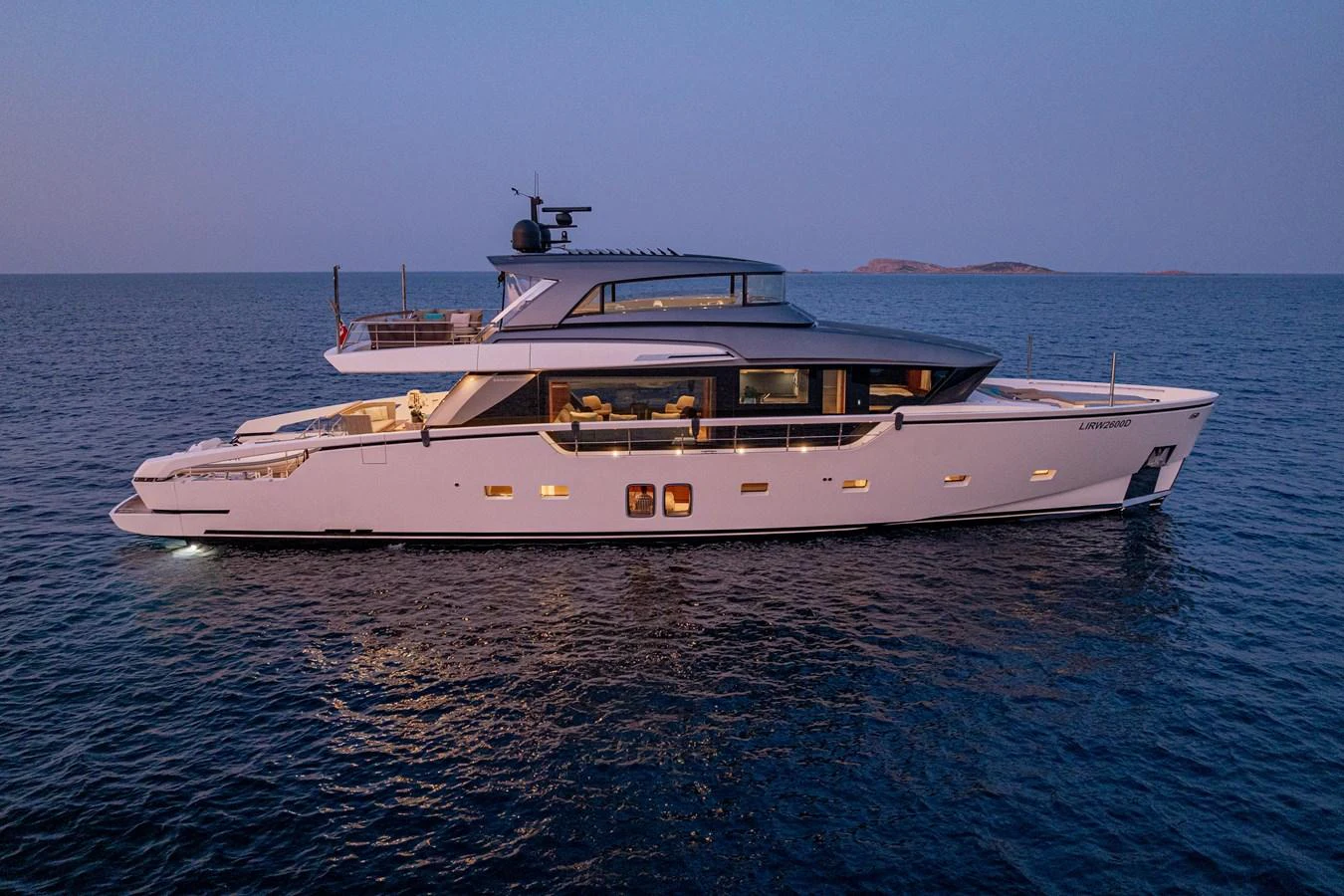 A sleek and modern yacht glides gracefully on calm waters during twilight. aboard SANLORENZO SX 88 M&M Yacht for Sale