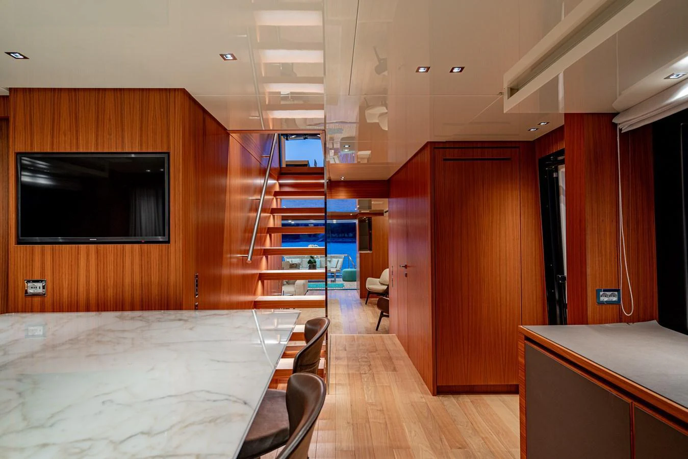 The yacht's interior features a modern design with wooden paneling and a marble countertop. aboard SANLORENZO SX 88 M&M Yacht for Sale