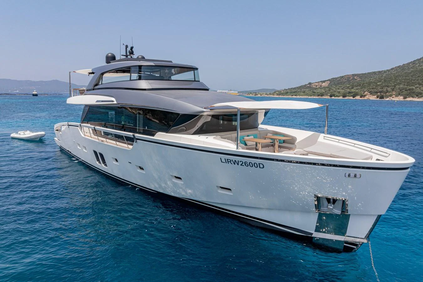 A sleek and modern yacht glides gracefully on clear blue waters, showcasing its elegant design and spacious deck areas. aboard SANLORENZO SX 88 M&M Yacht for Sale