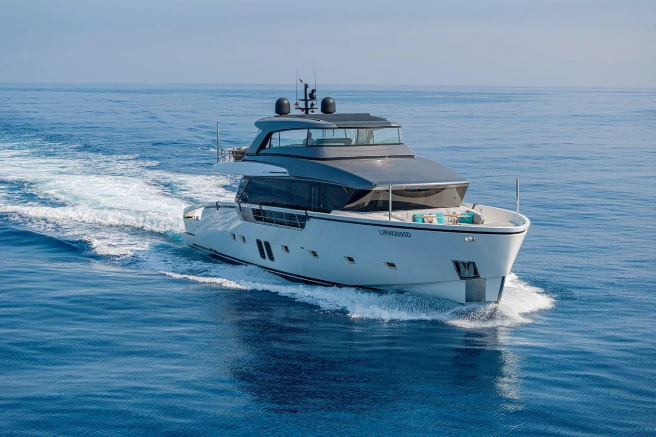 A sleek, modern yacht cruises smoothly on calm blue waters, showcasing its elegant design and spacious deck areas. aboard SANLORENZO SX 88 M&M Yacht for Sale
