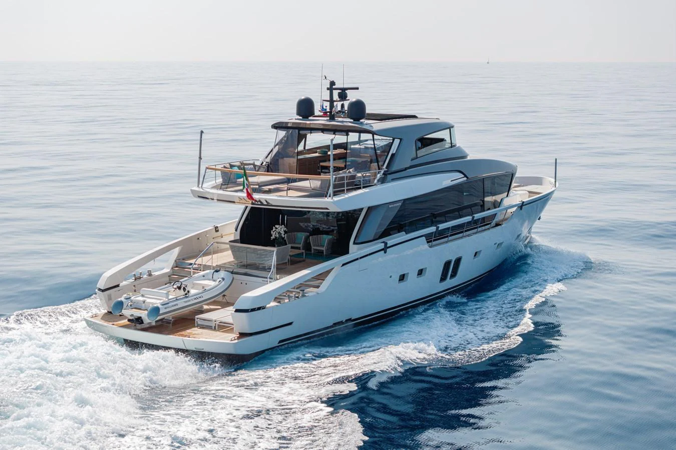 A sleek and modern yacht cruising on calm waters, showcasing its elegant design and spacious decks. aboard SANLORENZO SX 88 M&M Yacht for Sale