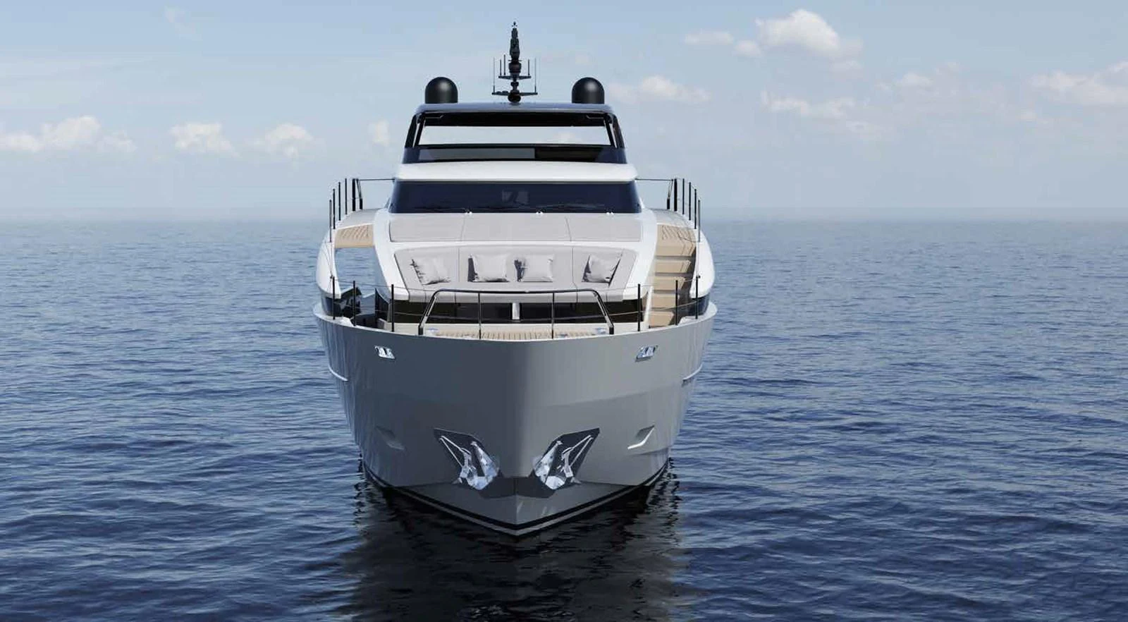 A sleek yacht is shown head-on, cutting through calm waters under a clear sky. aboard TELL NO ONE Yacht for Sale