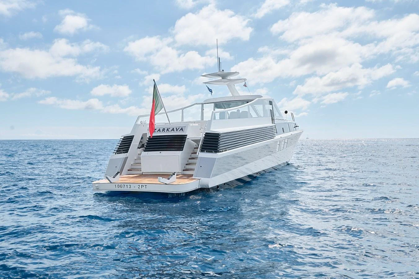 A sleek and modern yacht cruising on calm blue waters under a bright sky. aboard ZARKAVA Yacht for Sale