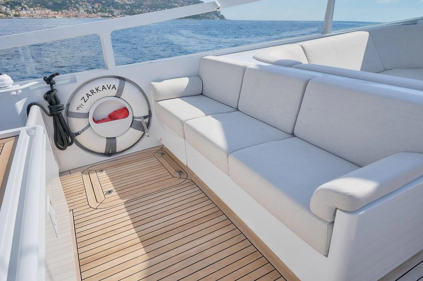 The aft deck features comfortable seating with a scenic view of the coastline. aboard ZARKAVA Yacht for Sale