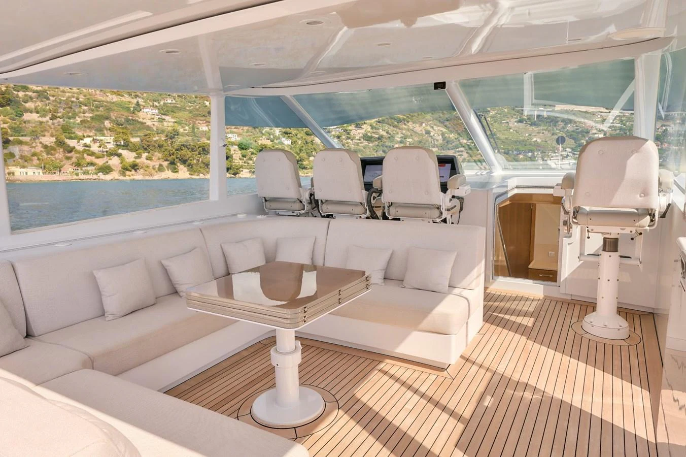 The flybridge offers a spacious seating area with plush cushions and a central table, perfect for relaxation and socializing. aboard ZARKAVA Yacht for Sale