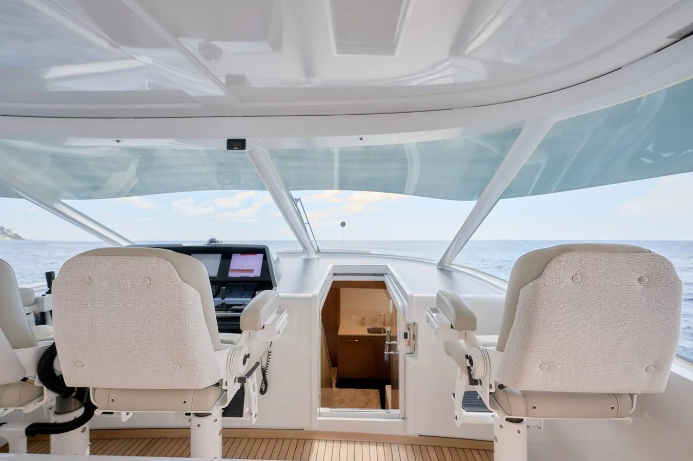 The helm station offers a commanding view with plush seating and advanced navigation equipment. aboard ZARKAVA Yacht for Sale