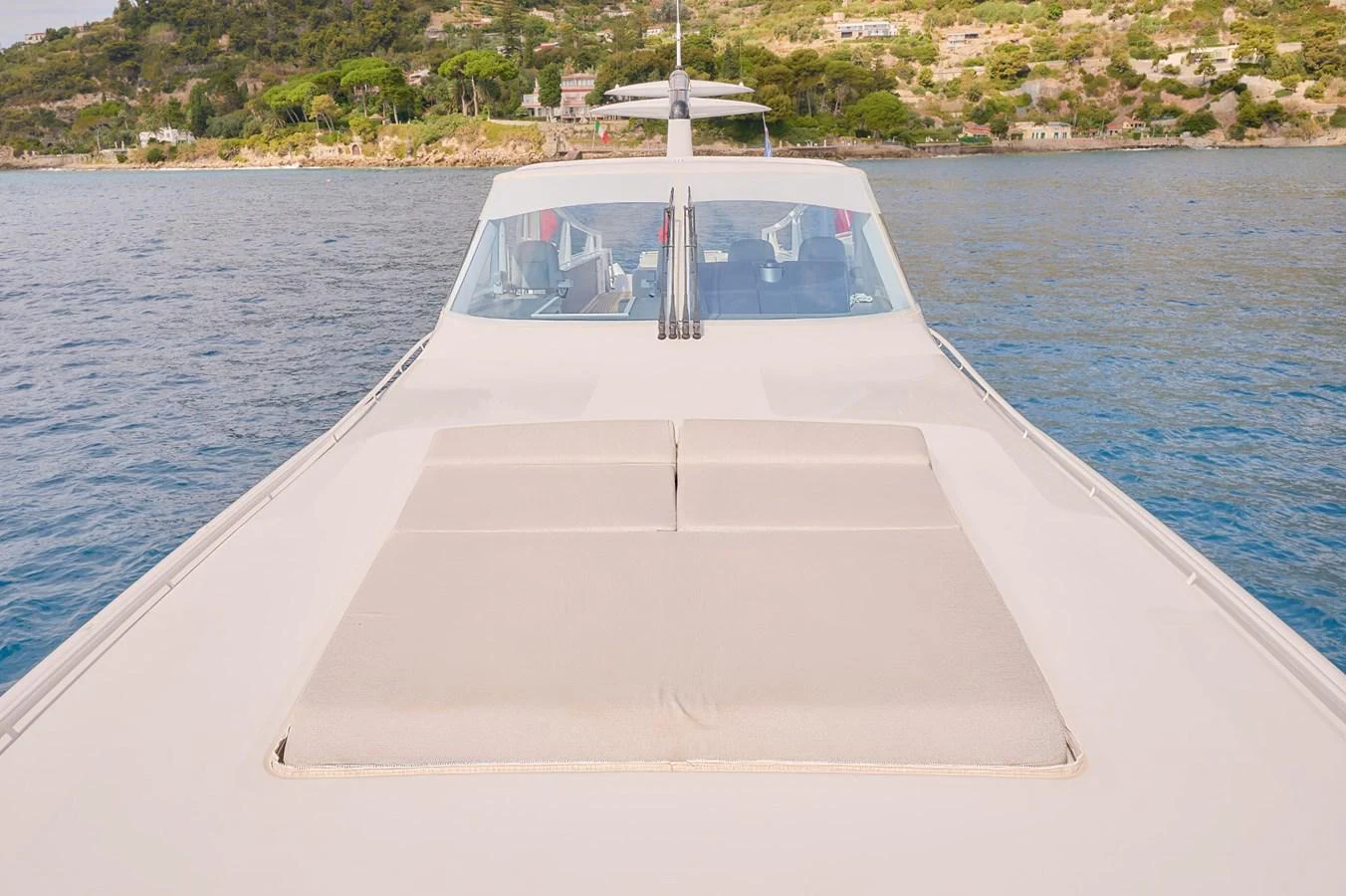 The yacht's foredeck features a spacious sunbathing area with plush cushions, offering a serene view of the surrounding waters. aboard ZARKAVA Yacht for Sale