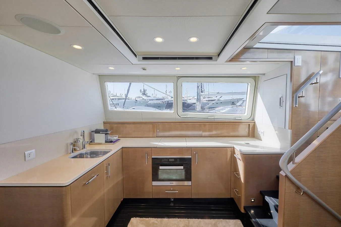The yacht's galley features modern appliances and ample counter space, illuminated by natural light from large windows. aboard ZARKAVA Yacht for Sale