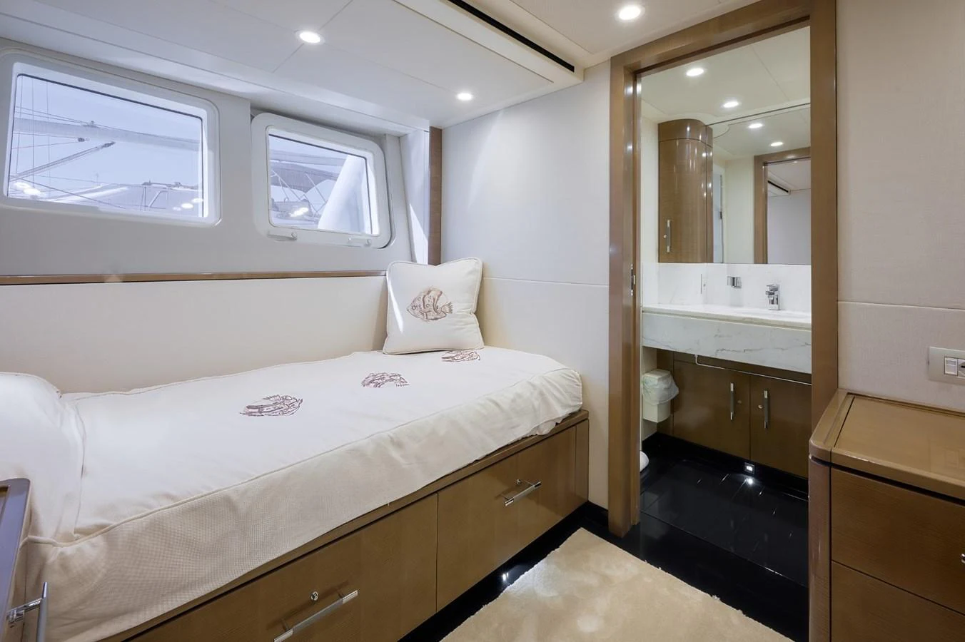 A cozy guest stateroom with a single bed and an ensuite bathroom. aboard ZARKAVA Yacht for Sale