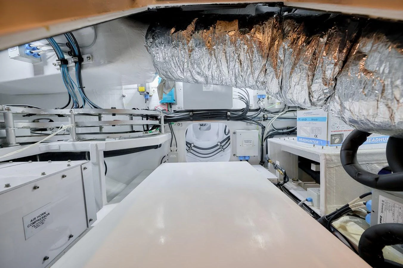 The image showcases the yacht's well-organized engine room with visible ductwork and machinery. aboard ZARKAVA Yacht for Sale