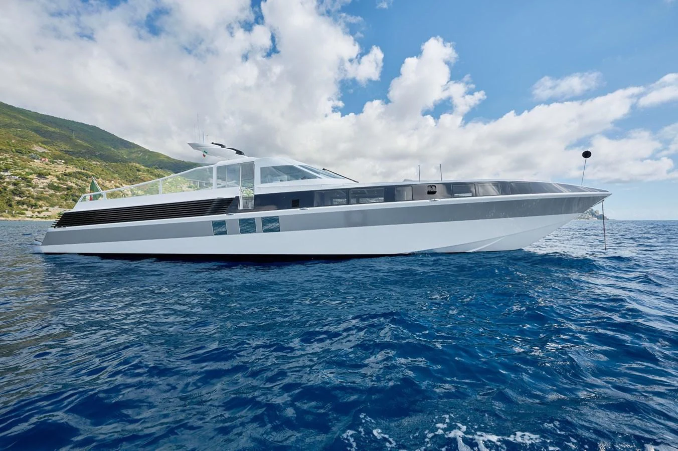 A sleek, modern yacht glides gracefully on the open water under a bright, clear sky. aboard ZARKAVA Yacht for Sale