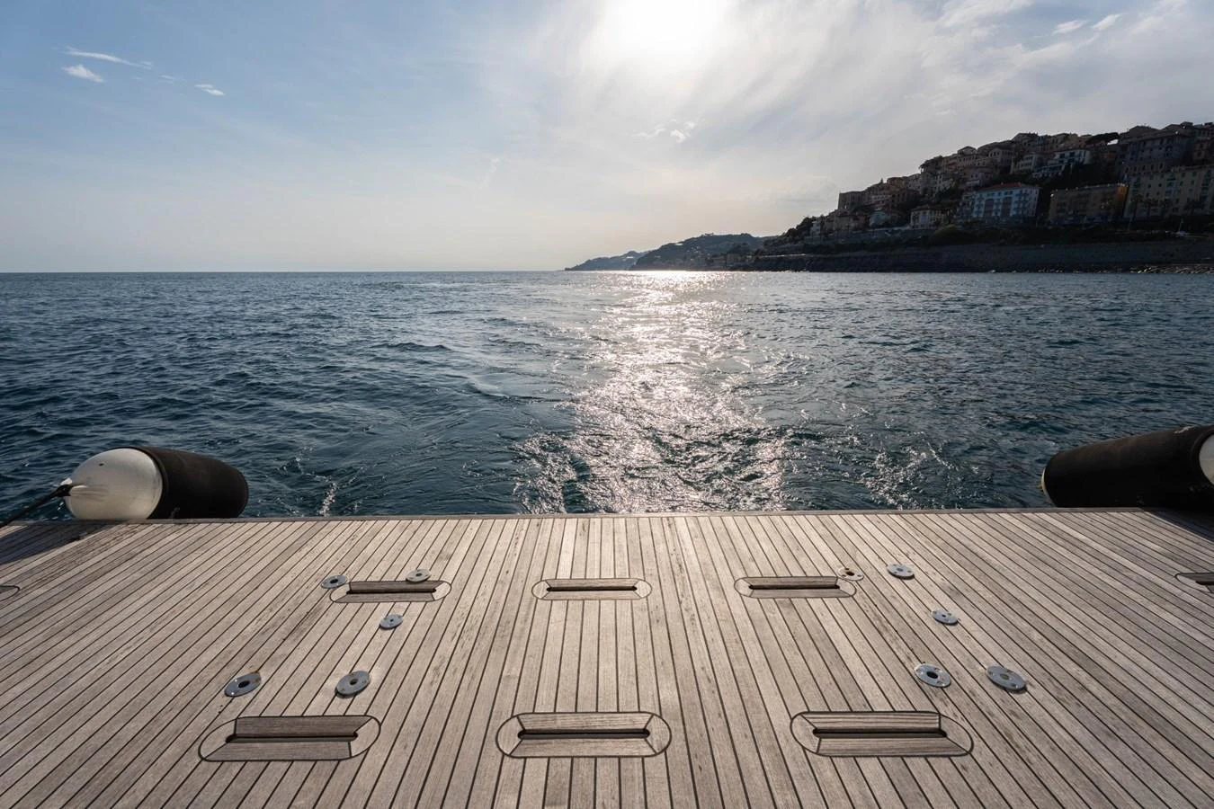 The image showcases a spacious swim platform with a scenic ocean backdrop. aboard TRINIDAD Yacht for Sale