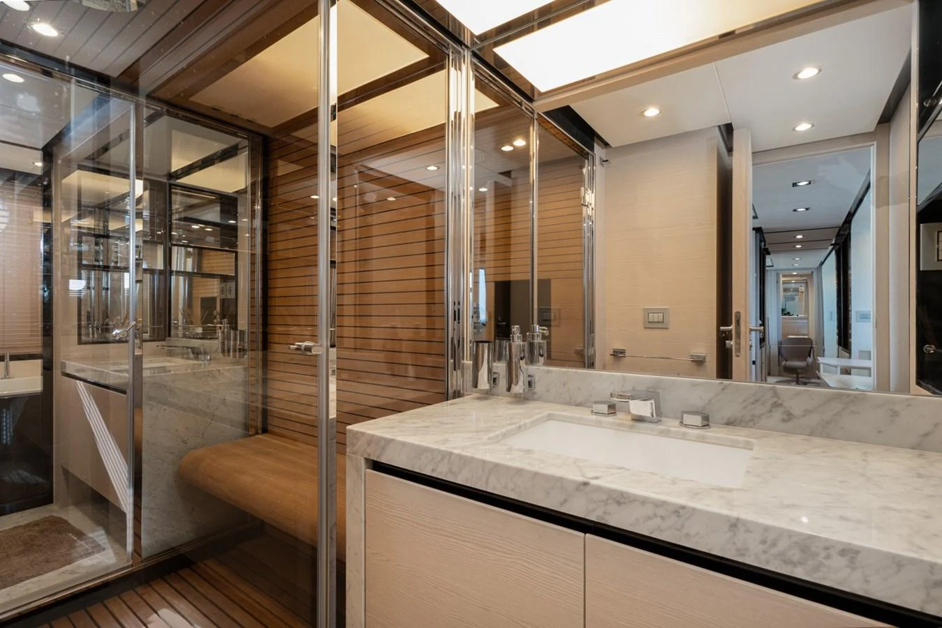 The yacht's bathroom features a luxurious marble countertop and modern fixtures. aboard TRINIDAD Yacht for Sale