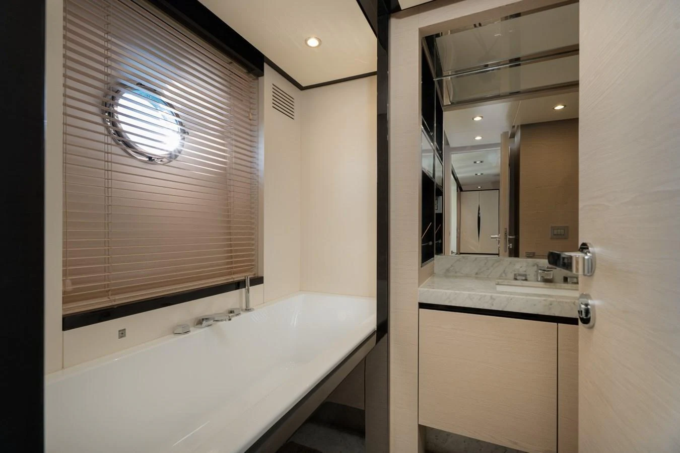 The yacht's bathroom features a sleek design with a bathtub and modern fixtures. aboard TRINIDAD Yacht for Sale