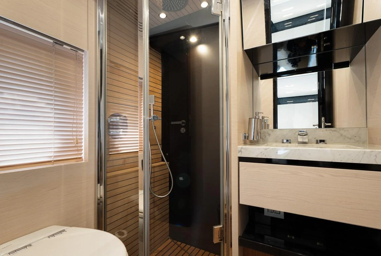 A modern yacht bathroom featuring a sleek shower and elegant vanity. aboard TRINIDAD Yacht for Sale