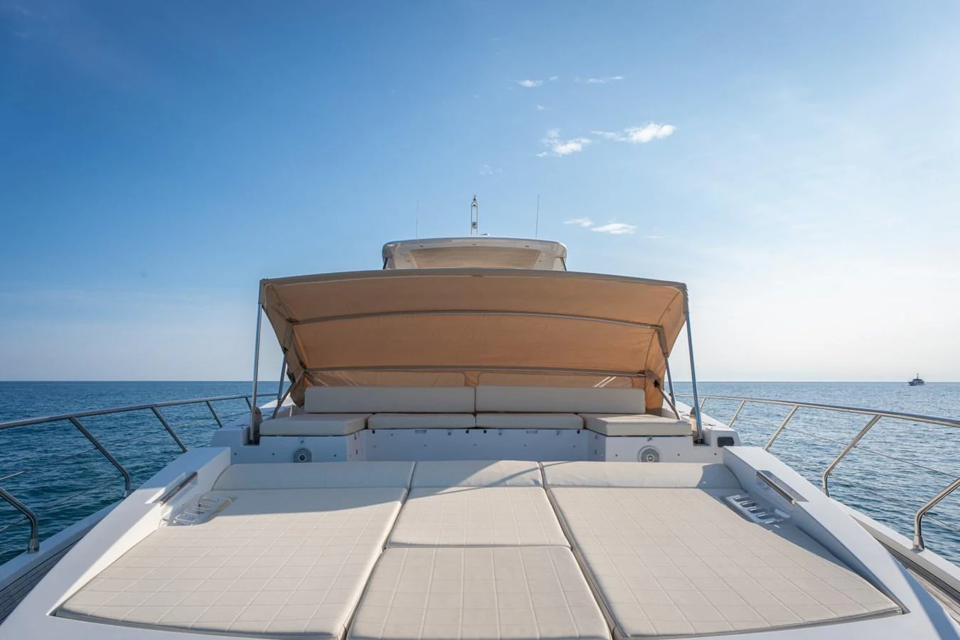 The foredeck features spacious sun pads with a retractable sunshade, perfect for relaxation. aboard TRINIDAD Yacht for Sale